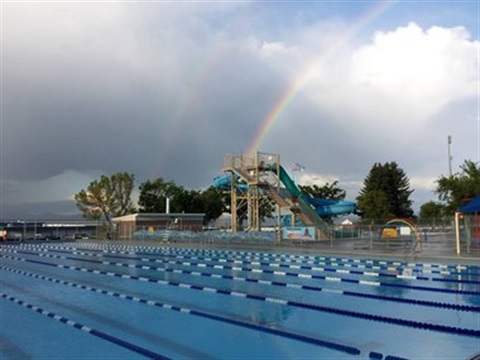 Picture of the slide tower with a rainbow in the background
