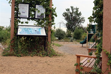 Bench and sign at 6th Ward Park.