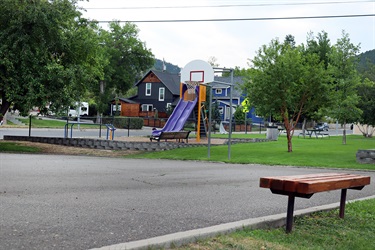 Bench next to a basketball court at Clinton Park.