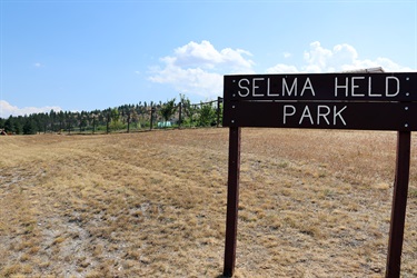 Wood sign at Selma Held Park.