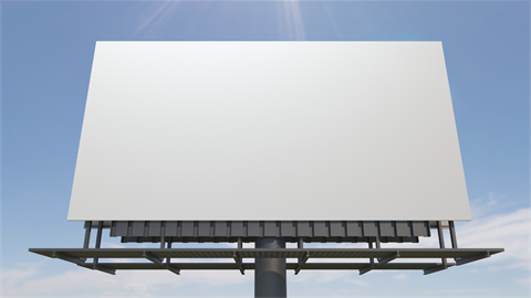 Blank billboard with blue sky in the background.
