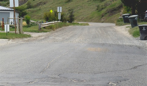 Photo of a city street that turns into a dirt road.