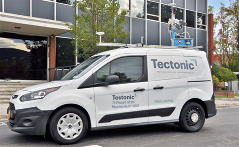 White van with street surveying equipment mounted on the roof.