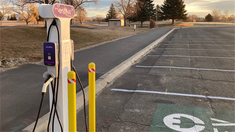 Electric vehicle charging station in a parking lot.