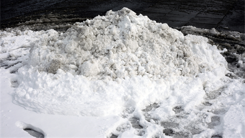Small pile of snow on pavement.