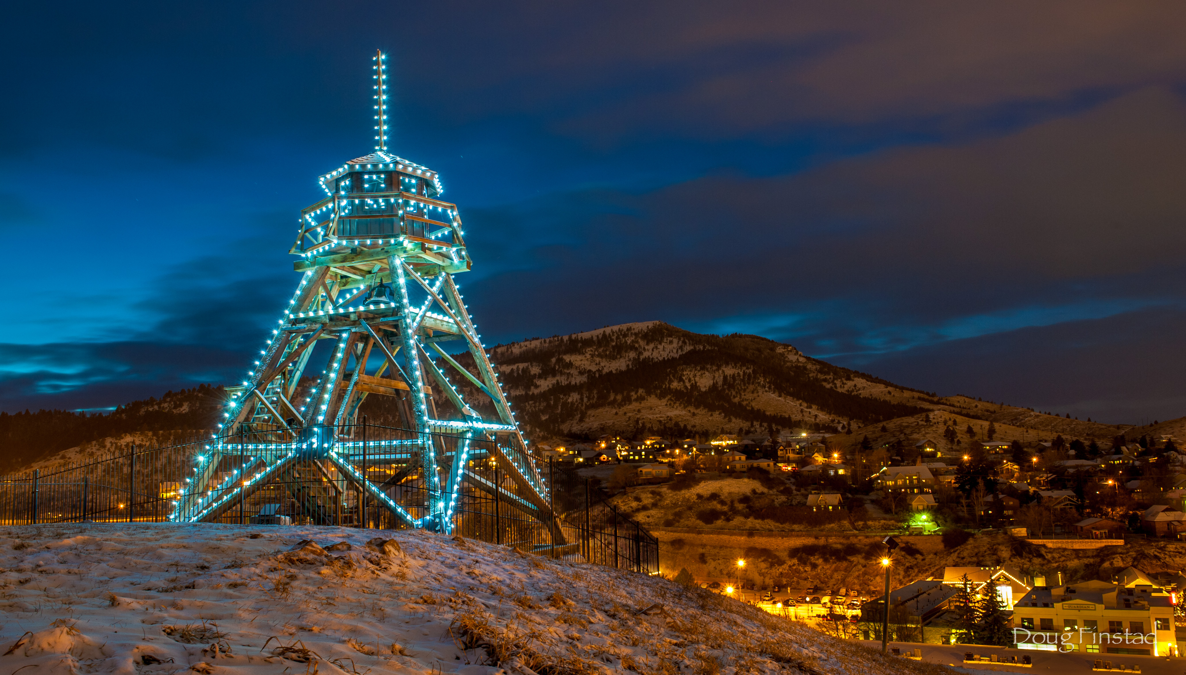 Evening view of the fire tower lit with blue lights.
